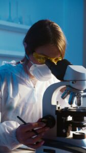 Researcher using a microscope